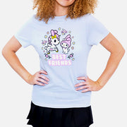 Front view of person wearing light grey t-shirt. Unicorno and My melody stand next to each other surrounded by flowers. Below my melody is white text that says best friends.