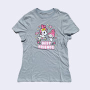Front side of light grey t-shirt. Center chest area shows Unicorno and My melody standing together surrounded by flowers. Below my melody is white text that says best friends.