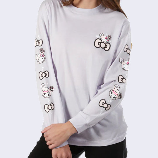 Light lavender gray long sleeve shirt, with a small graphic of Hello Kitty dressed as Donutella, peeping out from a pink bow. Along the sleeves of the shirt, is alternating graphics of pink bows, Hello Kitty's head dressed as Donutella, and Donutella's head.
