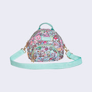 Slightly circular bag with a small front zipper pouch, and mint colored straps. Bag is covered completely in a busy pastel color pattern featuring tokidoki characters with cafe food and drink imagery.