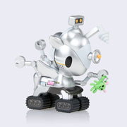 Unirover Unicorno, a silver metallic unicorn figure with many extra mechanical attachments and metal claw hands, one which holds a small green alien. Its feet are akin to how a rover moves.