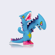 Vinyl "Kingdos" figure. A blue two-headed kaiju with a yellow star on its belly, purple spikes and pink sneakers.