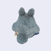 Back of Totoro plush, light gray and fluffy with a round tail.