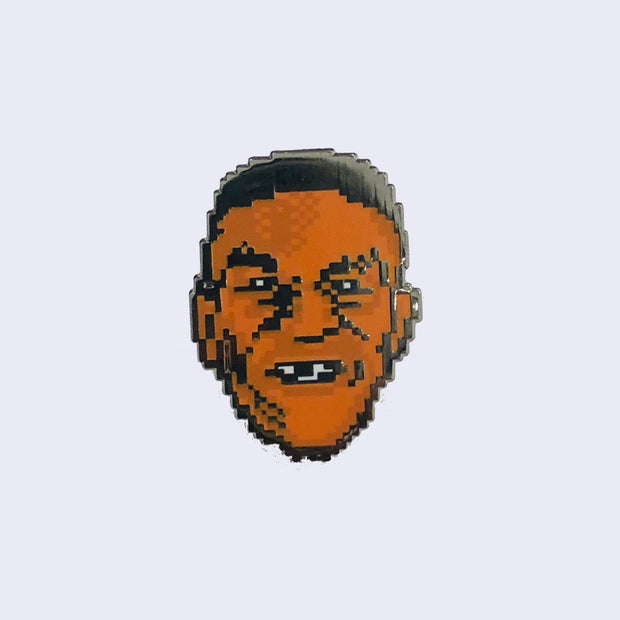 Enamel pin rendered in an 8-bit art style of a boxer's face.