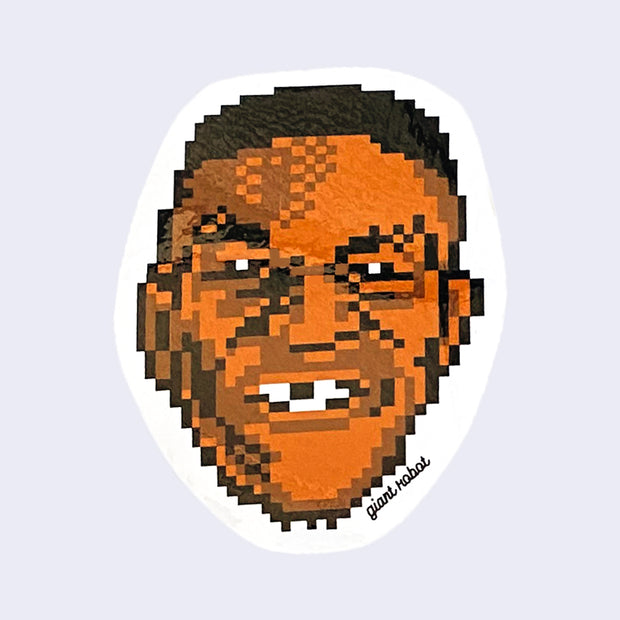 White cut out sticker of a 8-bit pixelated face with resemblance to Mike Tyson. "Giant Robot" is written in small black cursive in bottom right.