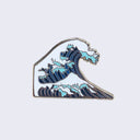 Enamel pin of a blue striped wave with white foam, akin to Hokusai print "The Great Wave off Kanagawa."