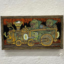 Illustration on wood with a yellow and black patterned border. 2 matching green monsters in pointy hats ride in a railroad cart that has a floating eyeball mechanism and a series of faces as the front of the car.